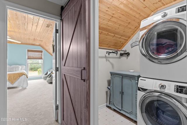 laundry area with light carpet, wooden ceiling, cabinet space, and stacked washer / drying machine