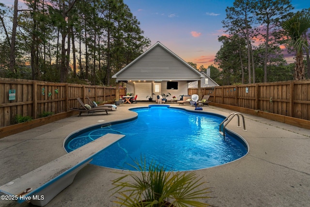 view of pool featuring a patio area, a fenced backyard, a fenced in pool, and an outbuilding