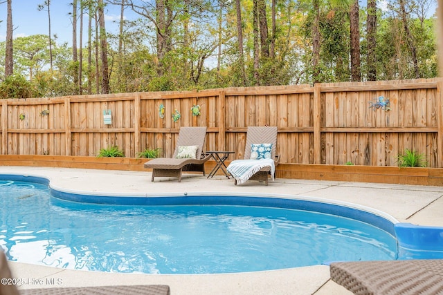 view of swimming pool with fence, a fenced in pool, and a patio