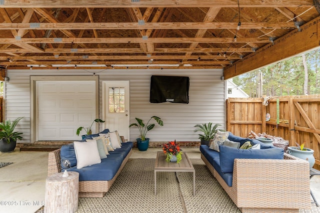 view of patio with an outdoor living space and fence