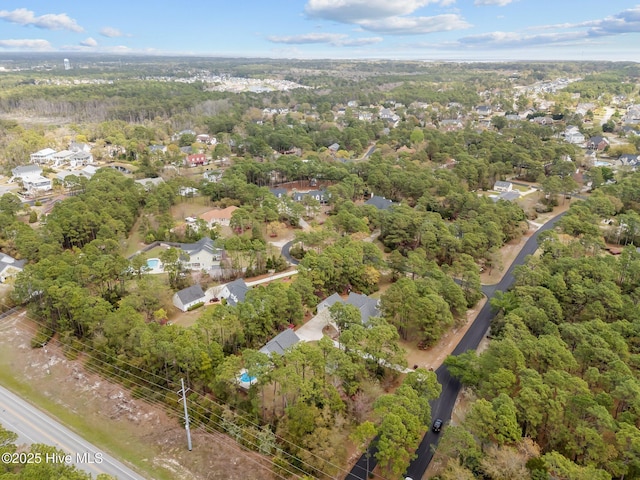 birds eye view of property featuring a wooded view