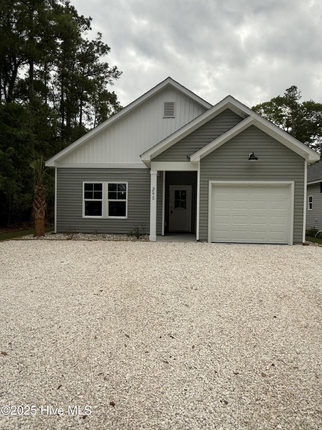 3572 Windy Point Rd SW, Supply, NC 28462 - view of front facade with driveway, a garage, and board and batten siding