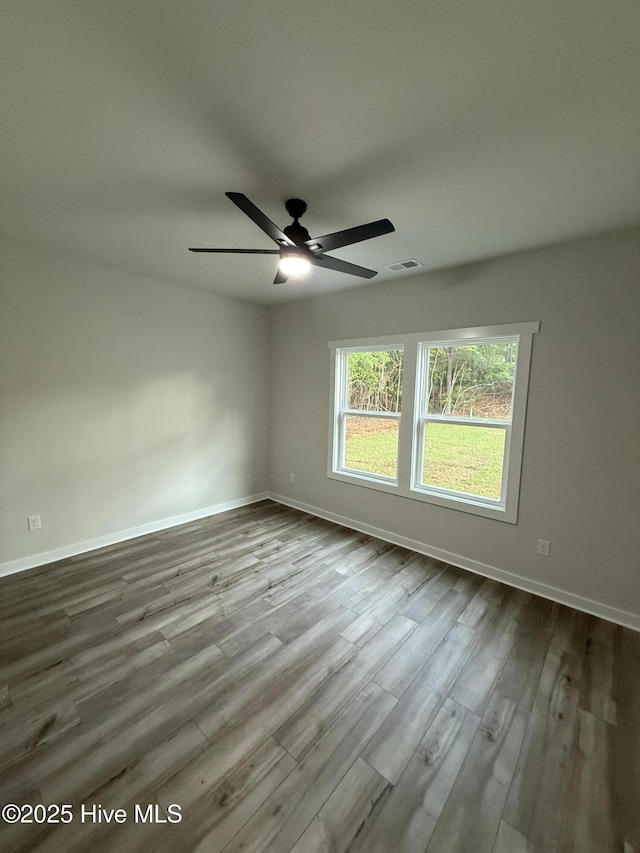 3572 Windy Point Rd SW, Supply, NC 28462 - empty room featuring ceiling fan, baseboards, and dark wood-style flooring