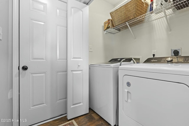 laundry area with washing machine and clothes dryer, dark wood-style floors, and laundry area