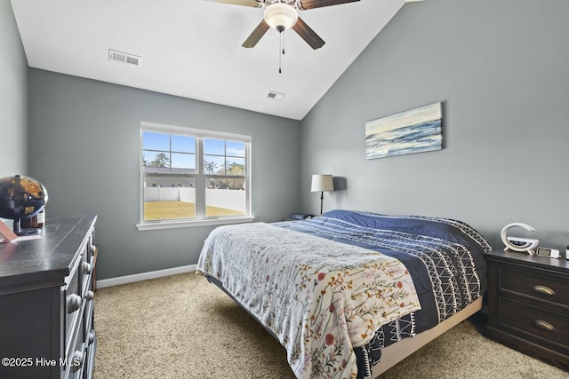 bedroom featuring light carpet, baseboards, visible vents, and lofted ceiling
