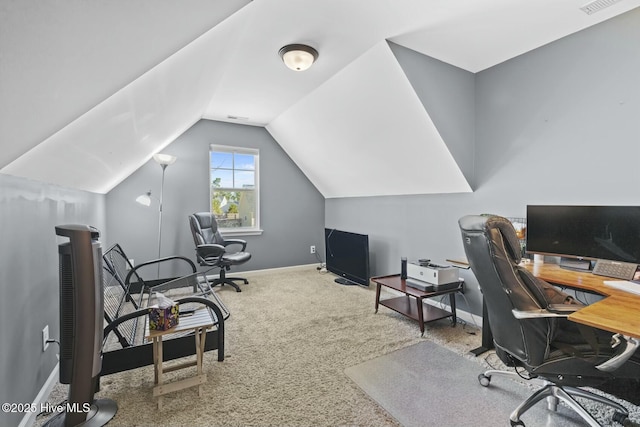carpeted home office featuring baseboards, visible vents, and vaulted ceiling