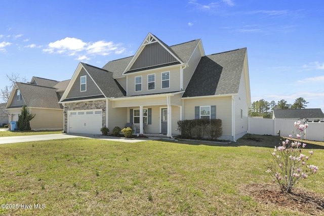 view of front facade with fence, an attached garage, a front yard, driveway, and a porch