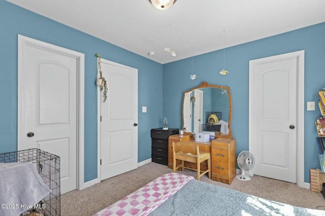 bedroom with baseboards and carpet