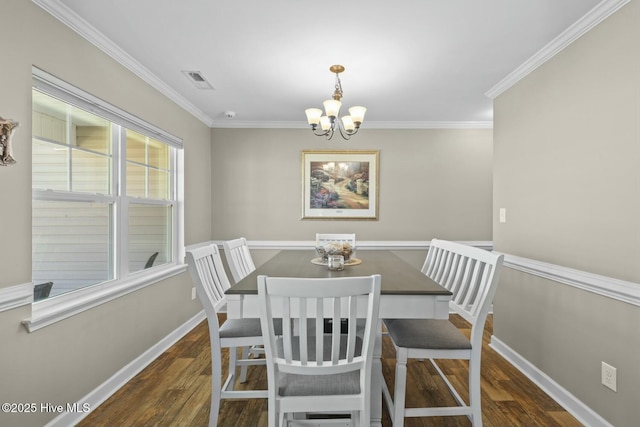 dining space with visible vents, crown molding, baseboards, wood finished floors, and an inviting chandelier