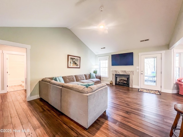 393 Knollwood Dr, Hampstead, NC 28443 - living room featuring vaulted ceiling, a fireplace, dark wood-style flooring, and baseboards