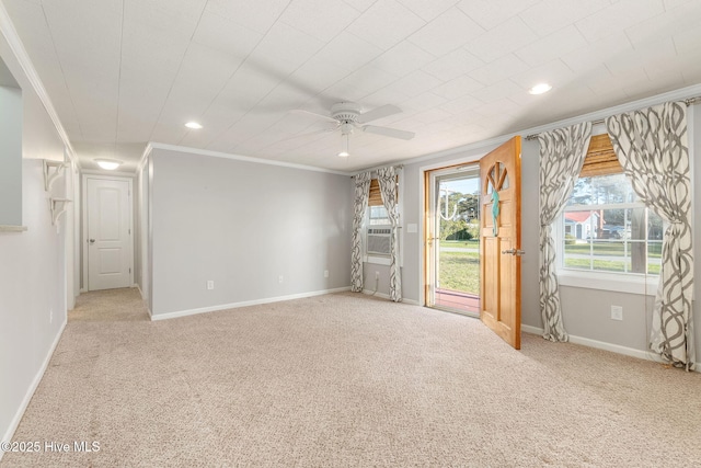carpeted spare room featuring recessed lighting, ornamental molding, baseboards, and ceiling fan