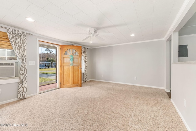 unfurnished room featuring electric panel, crown molding, baseboards, a ceiling fan, and carpet floors