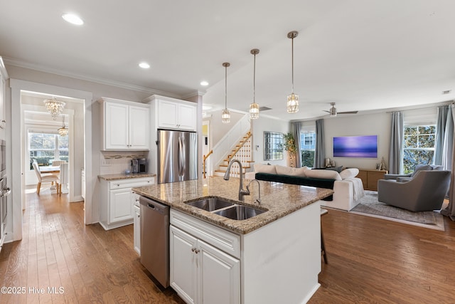 1025 Anchors Bend Way, Wilmington, NC 28411 - kitchen with stainless steel appliances, a sink, healthy amount of natural light, hardwood / wood-style floors, and ornamental molding