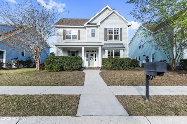 1025 Anchors Bend Way, Wilmington, NC 28411 - traditional home with a front yard, a porch, and board and batten siding