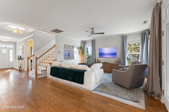 1025 Anchors Bend Way, Wilmington, NC 28411 - living room with a chandelier, stairs, crown molding, wood-type flooring, and healthy amount of natural light