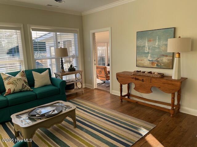 1325 Grandiflora Dr, Leland, NC 28451 - living room featuring baseboards, ornamental molding, and wood finished floors