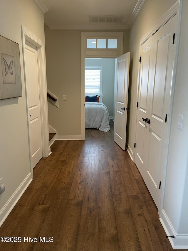 1325 Grandiflora Dr, Leland, NC 28451 - corridor with crown molding, stairway, dark wood-type flooring, baseboards, and visible vents