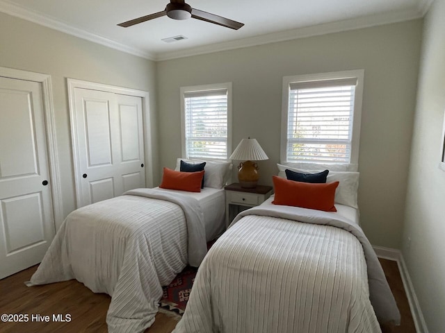 1325 Grandiflora Dr, Leland, NC 28451 - bedroom with wood finished floors, crown molding, baseboards, and visible vents