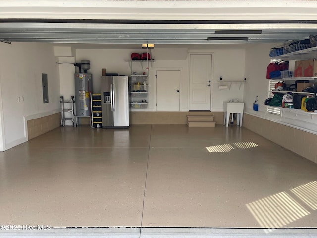 1325 Grandiflora Dr, Leland, NC 28451 - garage with stainless steel fridge with ice dispenser, electric water heater, and electric panel