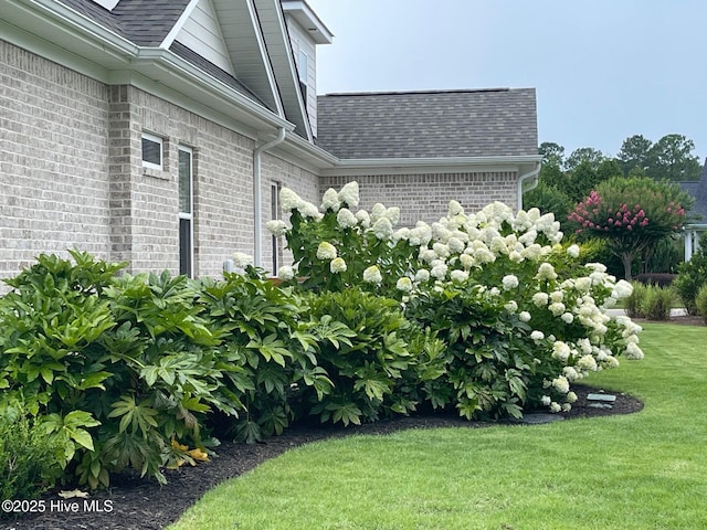 1325 Grandiflora Dr, Leland, NC 28451 - view of side of property with roof with shingles, brick siding, and a yard