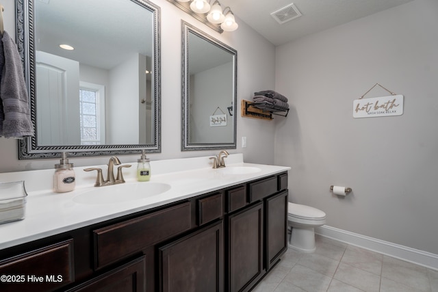 full bathroom featuring double vanity, visible vents, toilet, and a sink