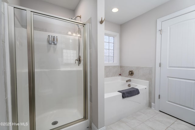 full bath featuring a bath, a stall shower, and tile patterned flooring