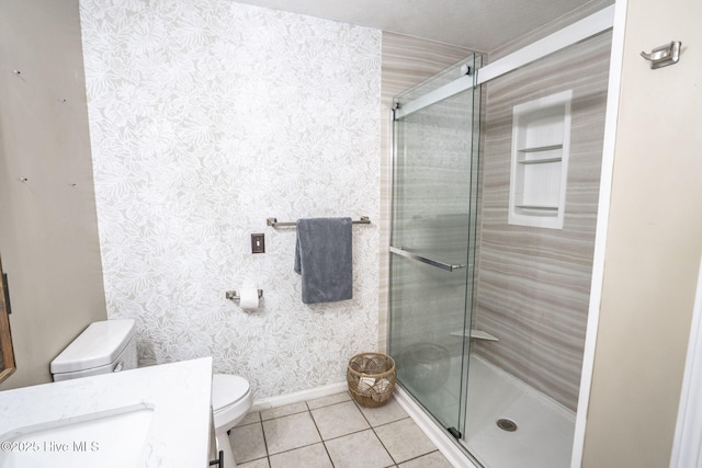 full bath featuring a stall shower, wallpapered walls, toilet, and tile patterned flooring