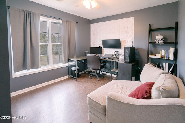 home office with a ceiling fan, baseboards, and wood finished floors
