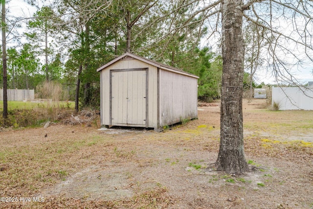 view of shed featuring fence