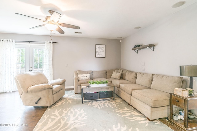 living area featuring visible vents, wood finished floors, and ceiling fan