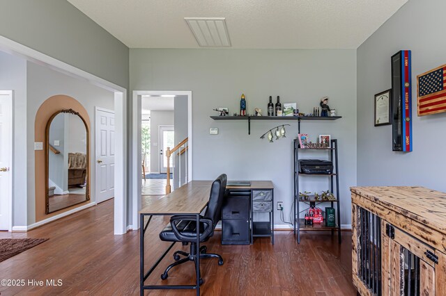 office area featuring visible vents, dark wood-style flooring, and baseboards