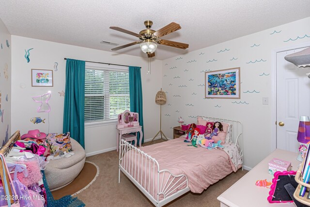 bedroom featuring carpet floors, a textured ceiling, a ceiling fan, baseboards, and visible vents