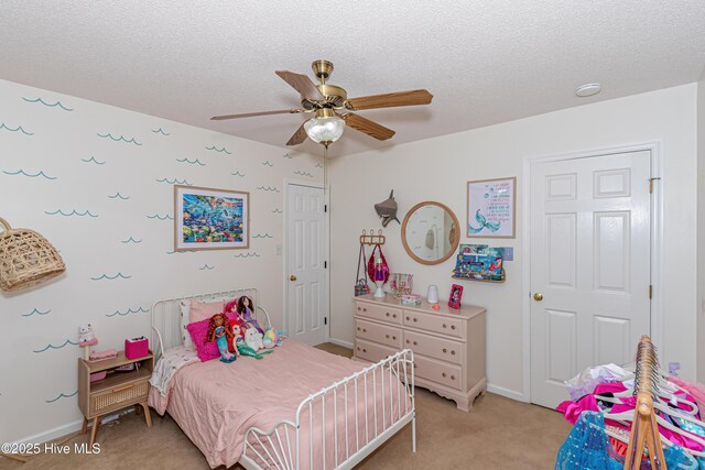 bedroom featuring light colored carpet, a textured ceiling, baseboards, and ceiling fan