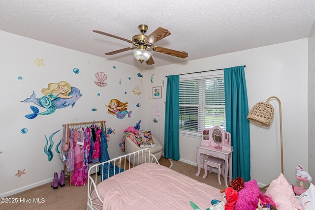 carpeted bedroom featuring baseboards, a textured ceiling, and ceiling fan