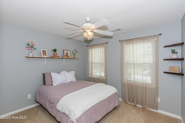 bedroom with multiple windows, carpet, and visible vents