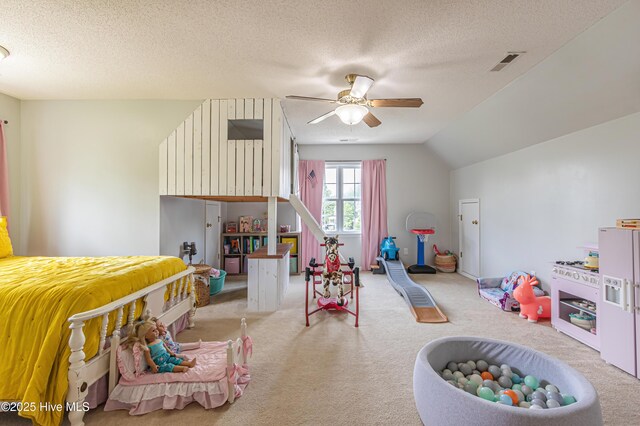bedroom featuring a textured ceiling, carpet, a ceiling fan, lofted ceiling, and visible vents