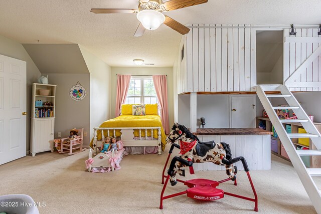rec room featuring carpet floors, a ceiling fan, and a textured ceiling