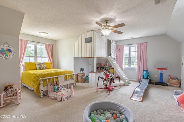 carpeted bedroom with ceiling fan, vaulted ceiling, a textured ceiling, and visible vents