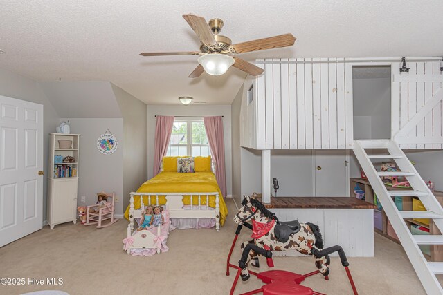 carpeted bedroom featuring a textured ceiling and ceiling fan