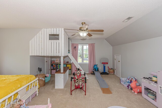 rec room featuring a ceiling fan, a textured ceiling, lofted ceiling, and light carpet