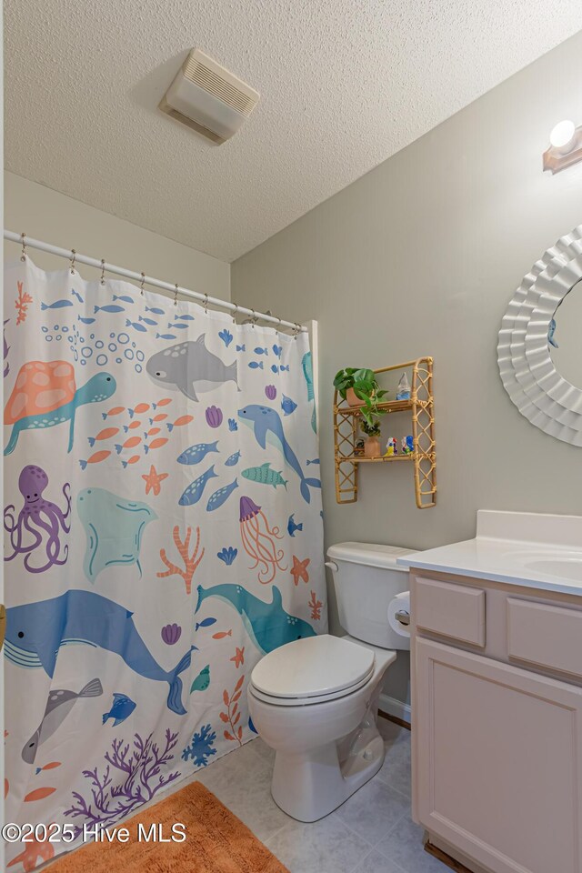 bathroom featuring tile patterned flooring, vanity, toilet, a textured ceiling, and visible vents