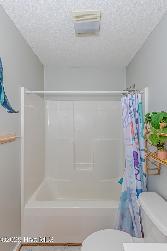bathroom with visible vents, shower / tub combo with curtain, a textured ceiling, and toilet