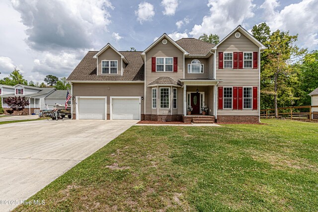 view of front of house featuring fence, driveway, roof with shingles, and a front lawn