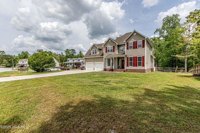 view of front of property featuring a garage, a front lawn, fence, and concrete driveway