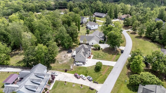 birds eye view of property featuring a residential view and a view of trees