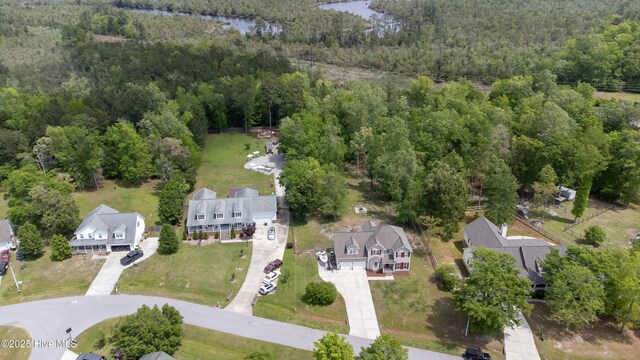 birds eye view of property featuring a water view, a view of trees, and a residential view