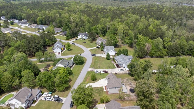 birds eye view of property with a residential view and a wooded view