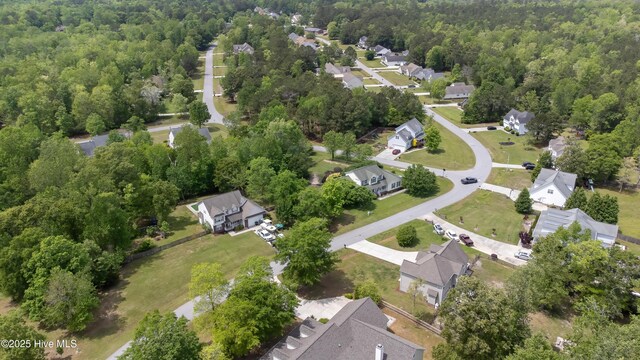 drone / aerial view with a residential view and a view of trees