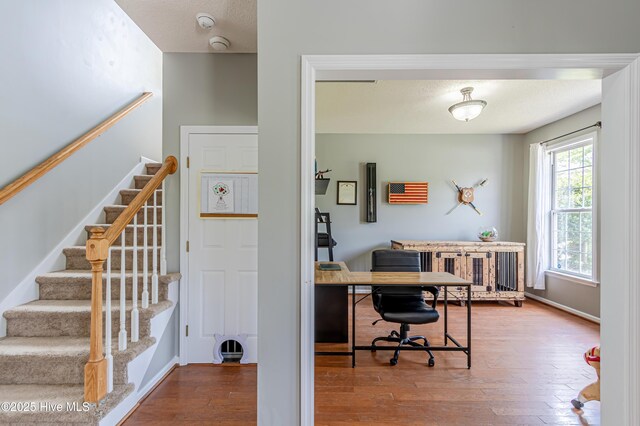 office area with wood-type flooring and baseboards