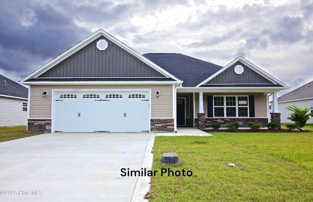 craftsman-style house with stone siding, an attached garage, a front lawn, board and batten siding, and driveway
